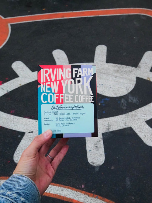 30th Anniversary Blend box held up in front of a New York mural