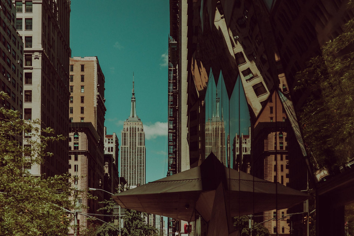 The Empire State Building framed between Midtown buildings