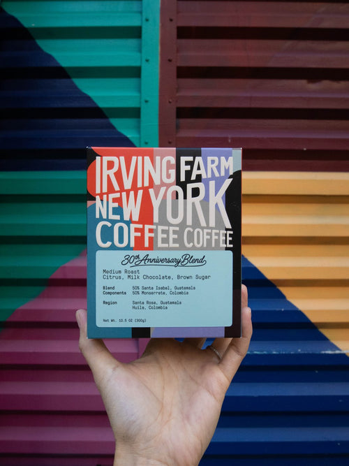 30th Anniversary Blend box held up in front of a New York mural