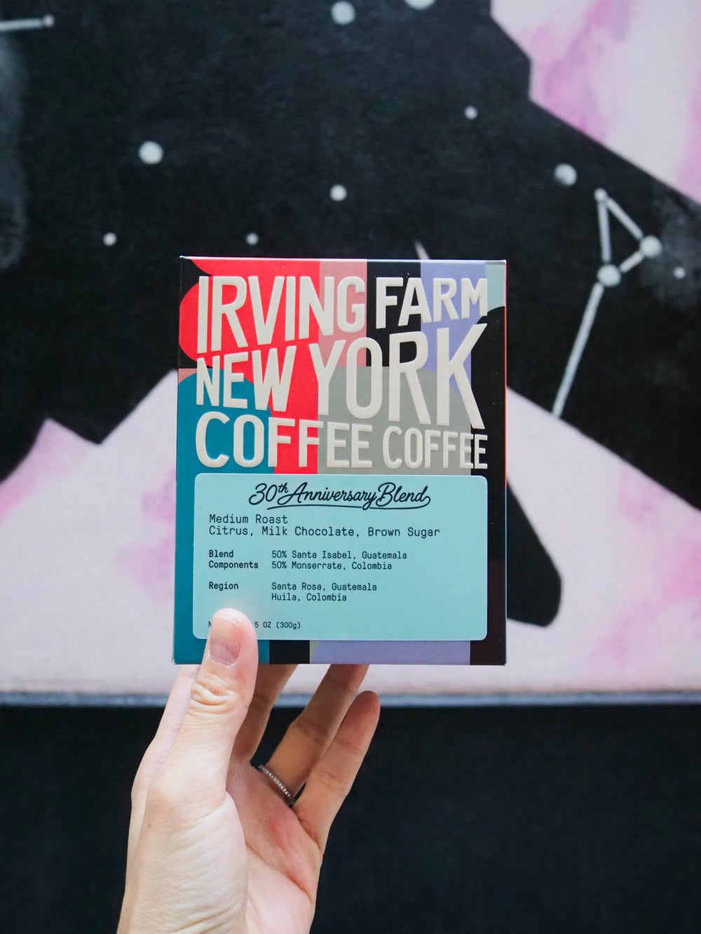 30th Anniversary Blend box held up in front of a New York mural